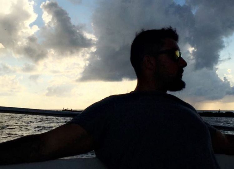 Matt Abati, founder of the Love Yours Foundation, on a boat at sunset